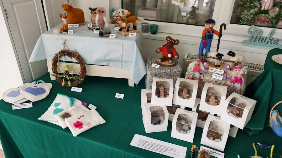 Highland cow, owls and foxes, a fir cone fairy wreath, lavender pouches and hedgehog air fresheners on the stall