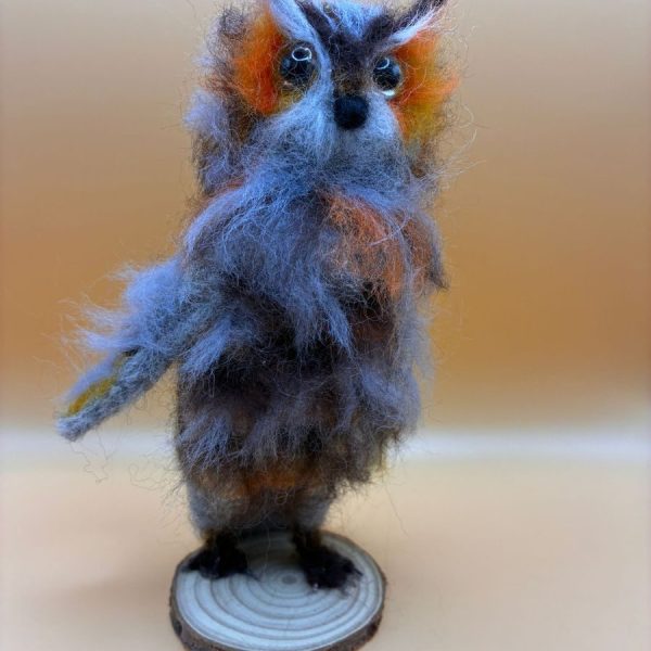 Baby owl on wood slice