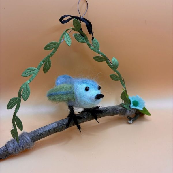 Blue bird on twig with leaf garland