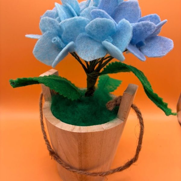 Blue hydrangea in wooden bucket