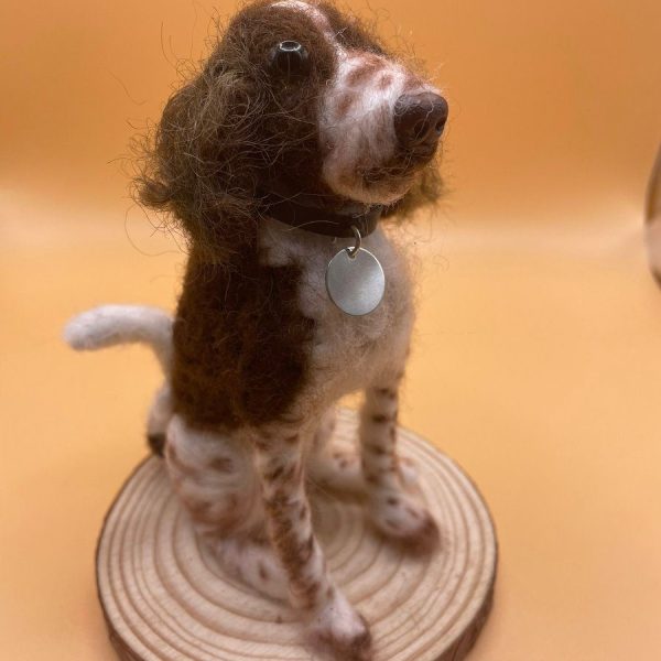 Brown and white dog on wood slice