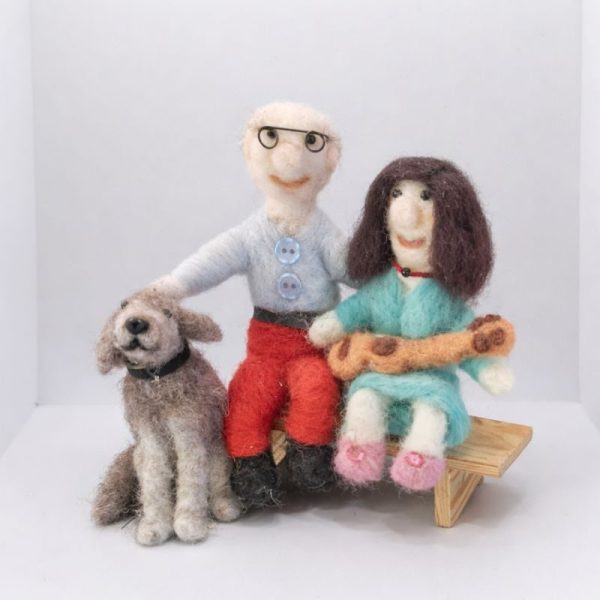 Couple sitting on bench with their dog