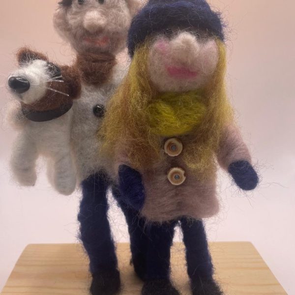 Couple with their dog on wooden base