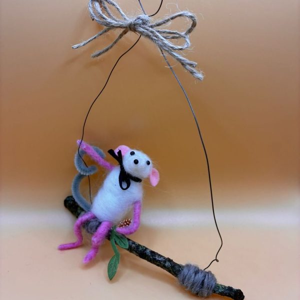 Mouse sitting on hanging twig