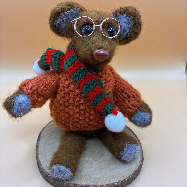 Mouse with glasses and scarf on wood slice