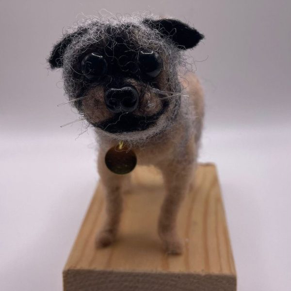 Small dog on wooden base