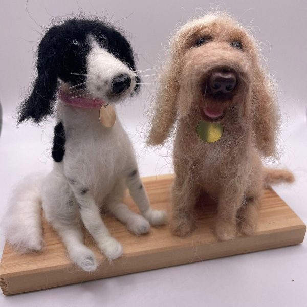 Two dogs on wooden board